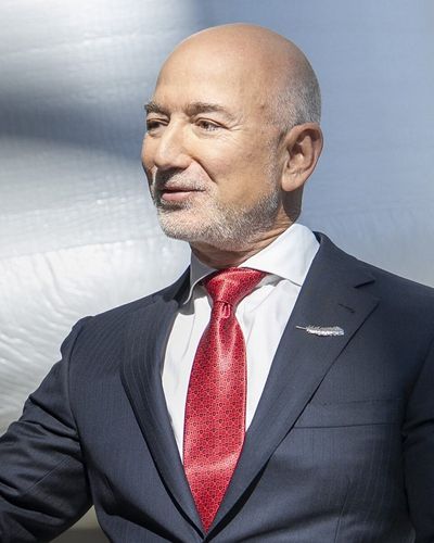 Jeff Bezos in a dark suit and red tie