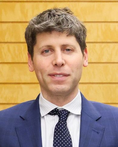 Sam Altman in a blue suit and dotted tie
